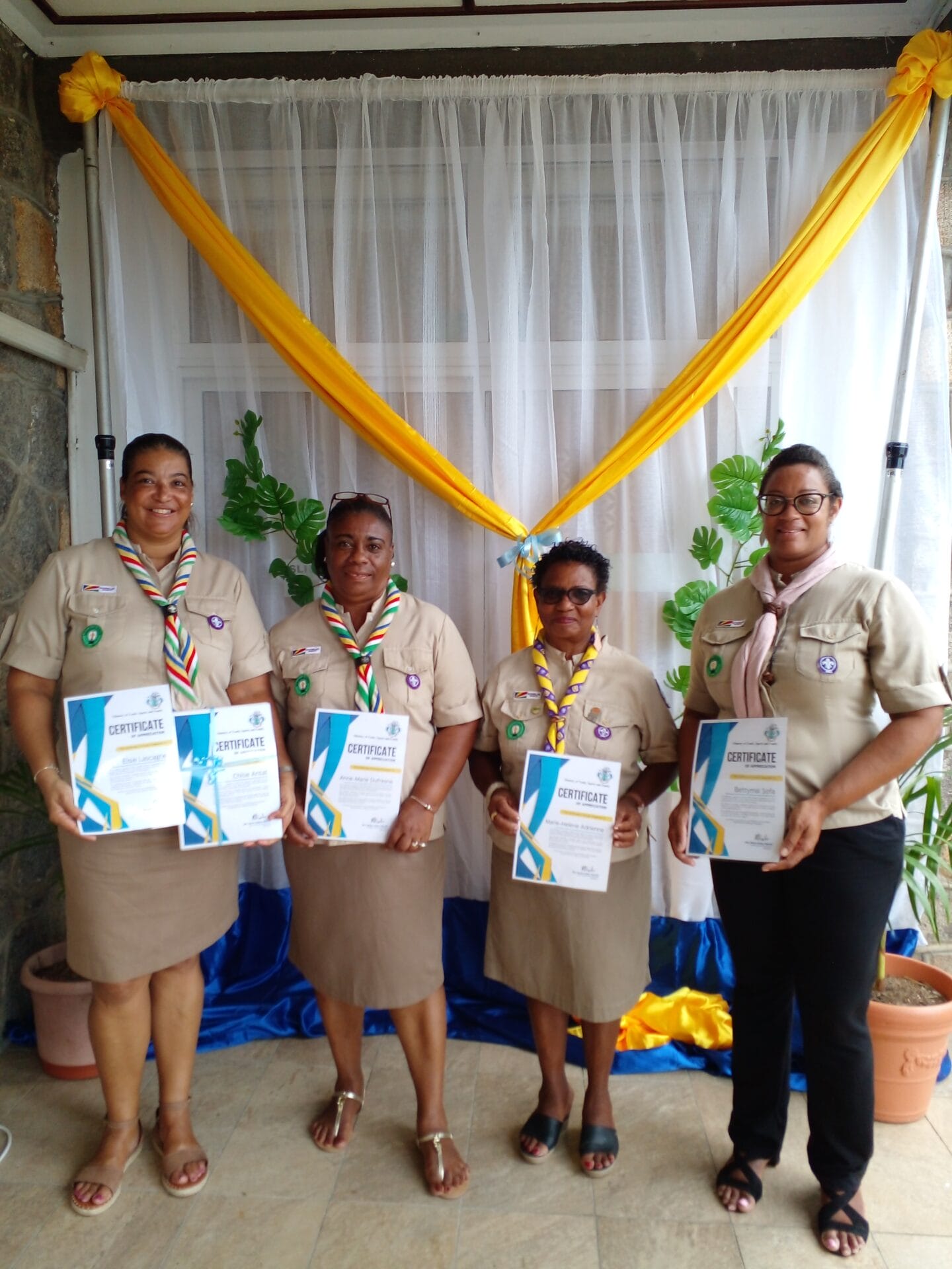 scout leaders posing with certificate of appreciation